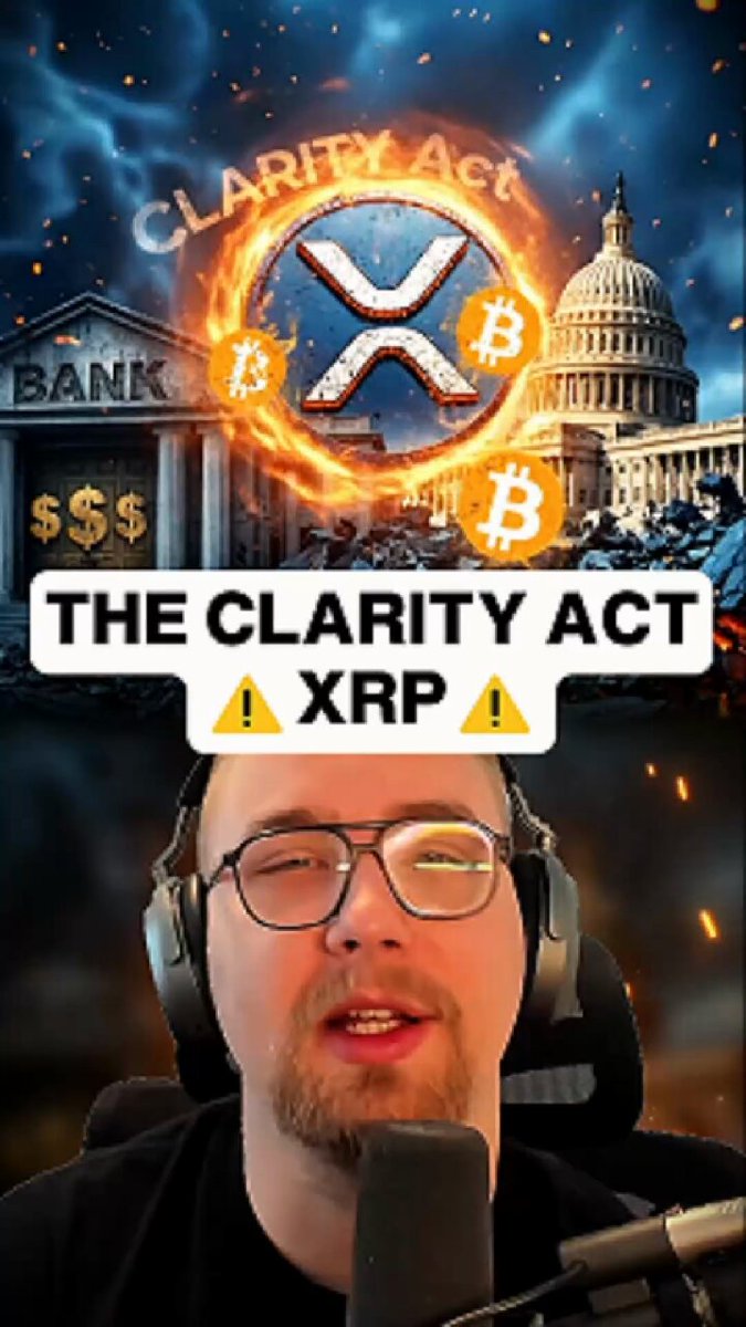 The image features a man wearing glasses, sitting behind a microphone with headphones on his head. The background of the image shows an illustration of a building with a fire burning inside it, surrounded by flames. The caption for the image reads "The clarity act BOMSHELL Why you need 1000 $XRP before July 4th?".