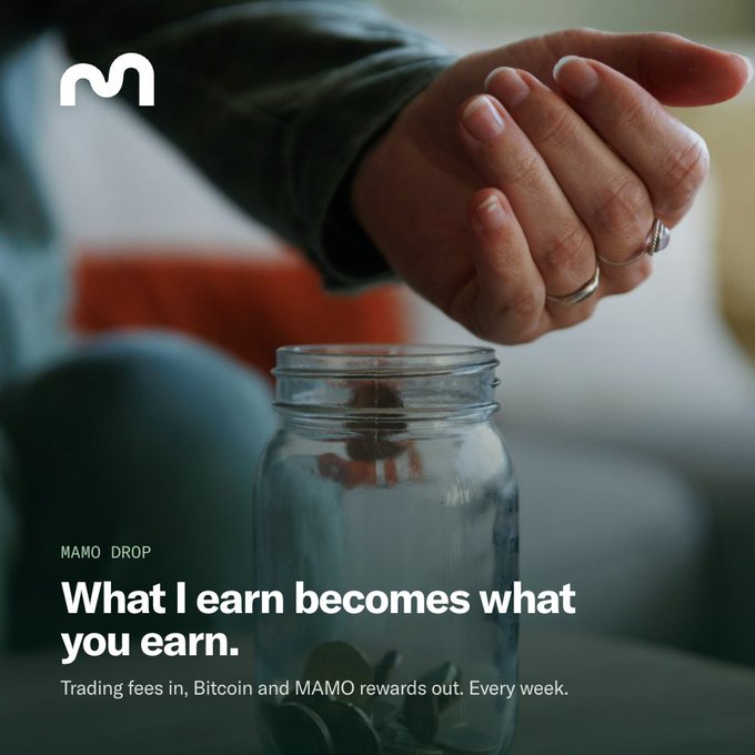 An advertisement shows hands dropping coins into a glass jar with text reading 'MAMO DROP', 'What I earn becomes what you earn', and 'Trading fees in, Bitcoin and MAMO rewards out. Every week.'