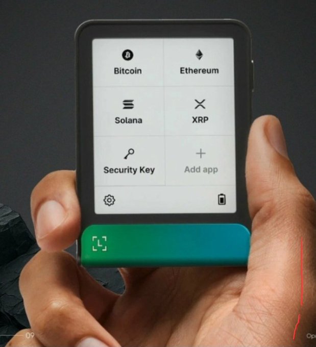 A hand holding a Ledger hardware wallet device displaying options for Bitcoin, Ethereum, Solana, XRP, Security Key, and Add app.