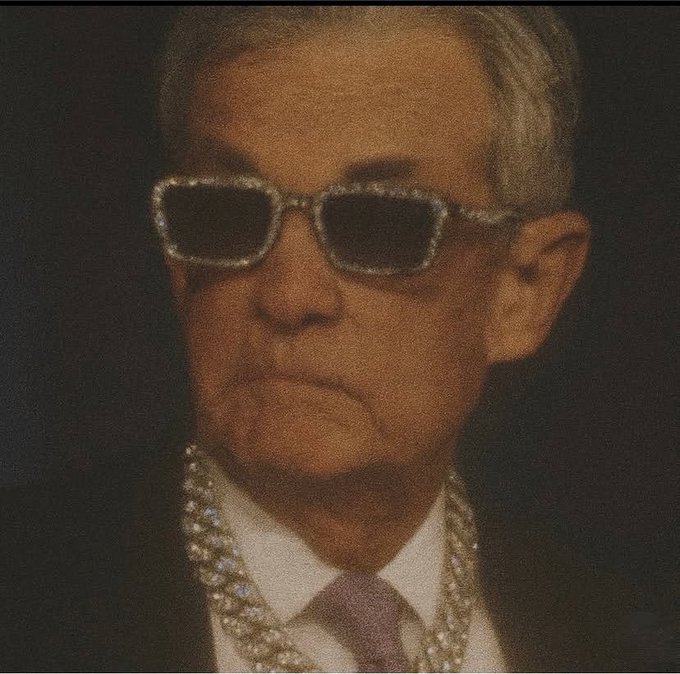 A stylized portrait of an older man with gray hair wearing dark sunglasses with rhinestone frames, a dark suit, white shirt, tie, and elaborate diamond jewelry.