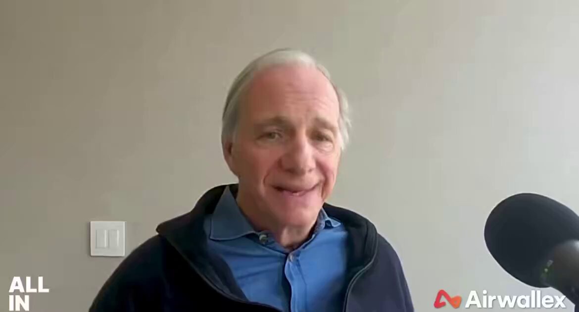 The image shows a man wearing a blue shirt, smiling at the camera while talking into a microphone. The caption reads "All In" with an Airwalax logo in the bottom right corner of the photo. The man appears to be discussing Bitcoin or cryptocurrency and expressing his concerns about its lack of privacy.