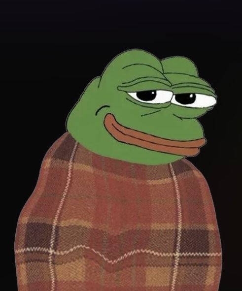 A digitally edited meme image of the Sad Pepe frog character wrapped in a red and brown plaid blanket against a black background.