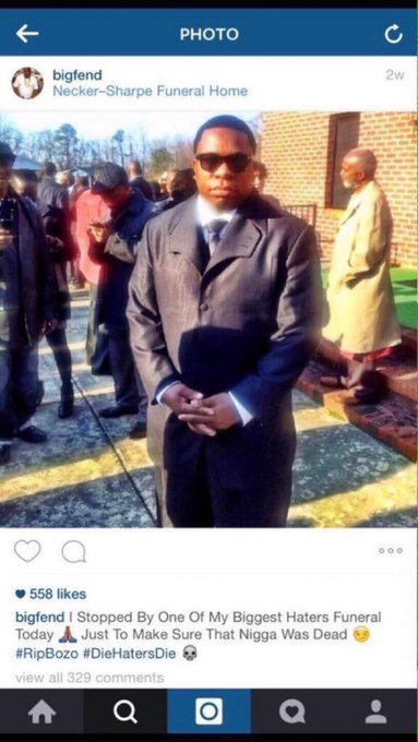 The image shows an Instagram post from user "bigfend" captioned "I Stopped By One Of My Biggest Haters Funeral Today 🙇🏾‍♂️ Just To Make Sure That Nigga Was Dead😳 #RipBozo #DieHatersDie 💀" at Necker-Sharpe Funeral Home, featuring a man in sunglasses and a dark suit standing outside the funeral home with 558 likes and 329 comments visible. The unrelated caption about market trading on Yom Kippur appears disconnected from the image's funeral context.