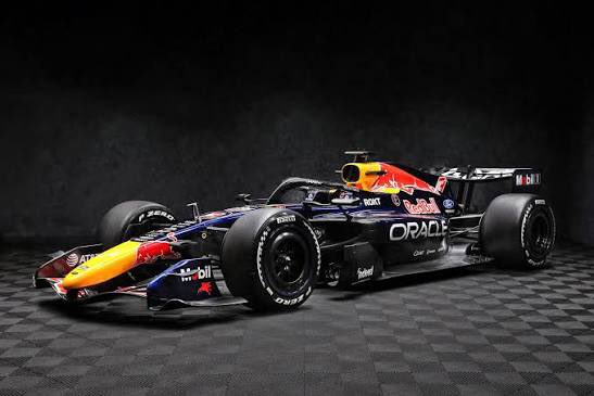A Red Bull Racing Formula 1 car displayed in a dark studio with Oracle, Mobil, and Honda branding.