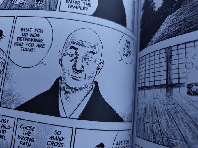 A close-up of an open manga page featuring a bald, smiling monk-like character with speech bubbles reading "WHAT YOU DO NOW DETERMINES WHO YOU ARE TODAY," "THE PAST IS THE PAST," and "CHOSE THE WRONG PATH," alongside panels showing a traditional Japanese temple setting. The image fits the "GM frens, have a great weekend" post by sharing an encouraging, mindful message about focusing on the present rather than dwelling on past mistakes—fitting wisdom for starting the weekend fresh.
