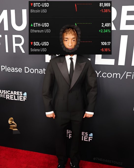 Jaden Smith stands on a red carpet in a black suit at the Musicares Relief event, with a cryptocurrency ticker overlay showing BTC-USD at 81,969 (-1.38%), ETH-USD at 2,491 (+2.34%), and SOL-USD at 109.17 (-6.16%).