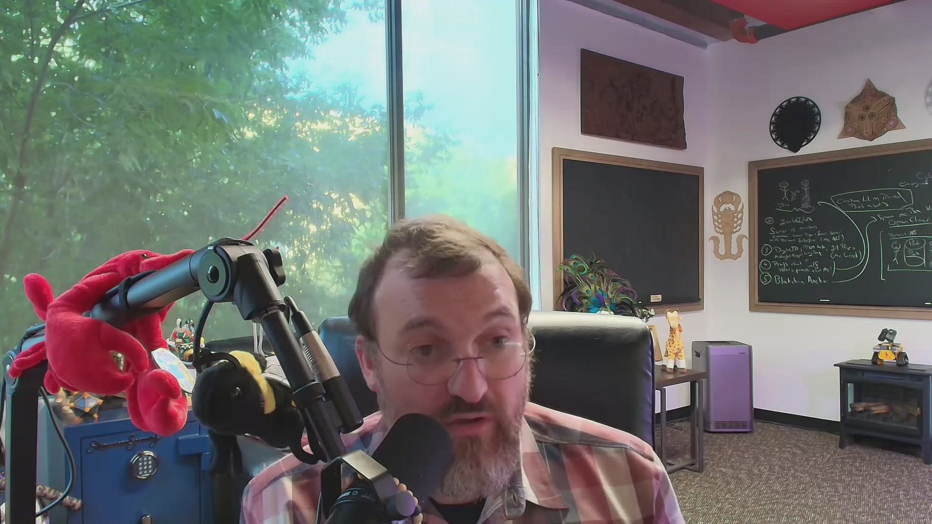 The image shows a man wearing glasses sitting at a desk with a microphone, likely participating in an online radio show or podcast. The room has a window that allows natural light into the space, creating a comfortable atmosphere for the host's recording session. In front of him is a red stuffed animal, adding a touch of personality to his workspace.

The post on social media features a quote from Charles Dickens' "A Tale of Two Cities" and encourages listeners to spread positivity in their communities. The image also includes a drawing of a man holding a book, which could be related to the quote or simply an artistic element within the post.