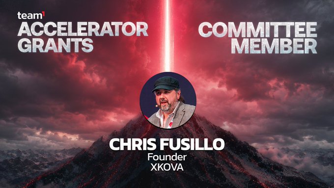 A promotional graphic announcing Chris Fusillo, Founder of XKOVA, as a new Committee Member of the Team1 Accelerator Grants program, set against a dramatic red and black mountainous backdrop with a laser-like light beam. The image features his professional headshot centered above his name and title, visually representing his appointment to the Avalanche ecosystem's grants committee.
