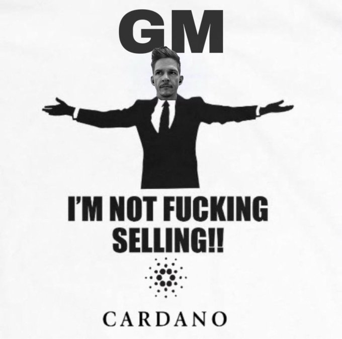 A parody shirt design featuring a man in a suit with outstretched arms, text reading 'GM I'M NOT FUCKING SELLING!!' and the 'CARDANO' logo at the bottom.