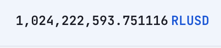 A digital display shows the number '1,024,222,593.751116' followed by the blue ticker 'RLUSD', likely representing a cryptocurrency balance.