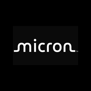 The image shows a logo with the word "MICRON", written in an all-caps, white font. The words are arranged diagonally across each other and set against a black background. Below this logo, there's a text that reads "BREAKING: ~$1.3T Micron $MU is now trading onchain via SunriseDeFi on Solana." This information might be related to the cryptocurrency market or a trade happening in real-time at the time the image was taken. The title of the post suggests it could be a story about the company's recent success or a review of its performance.