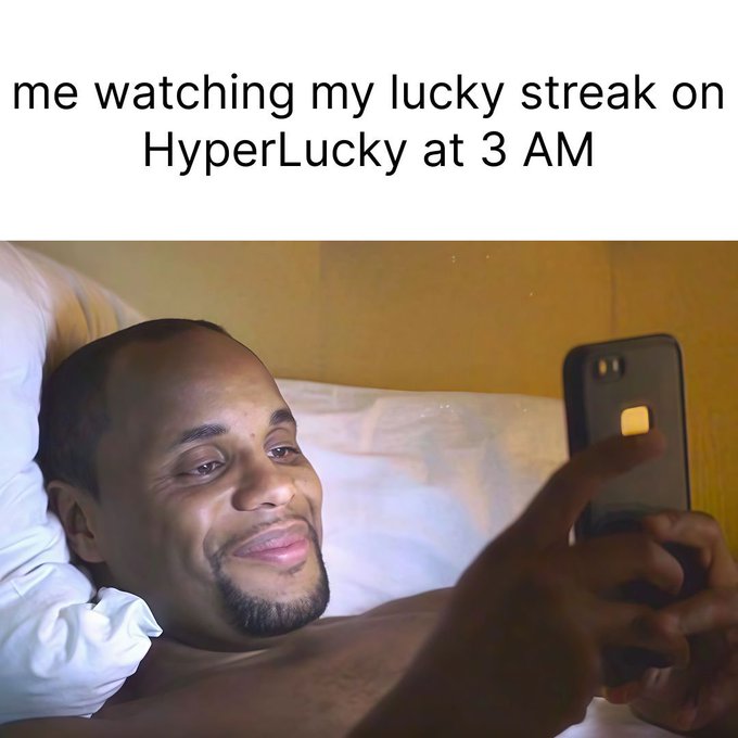 A meme captioned 'me watching my lucky streak on HyperLucky at 3 AM,' featuring a man lying in bed smiling at his smartphone.