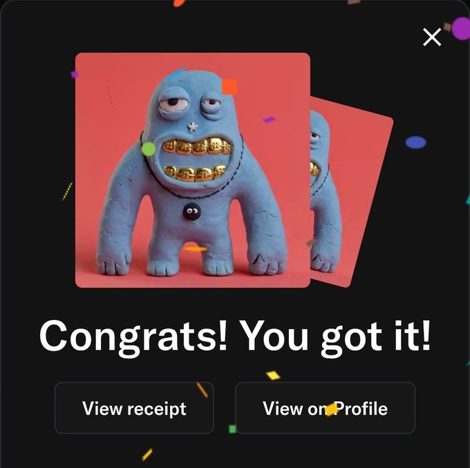 A 'Congrats! You got it!' notification showing a 3D blue monster figurine with gold teeth, with buttons to 'View receipt' or 'View on Profile.'
