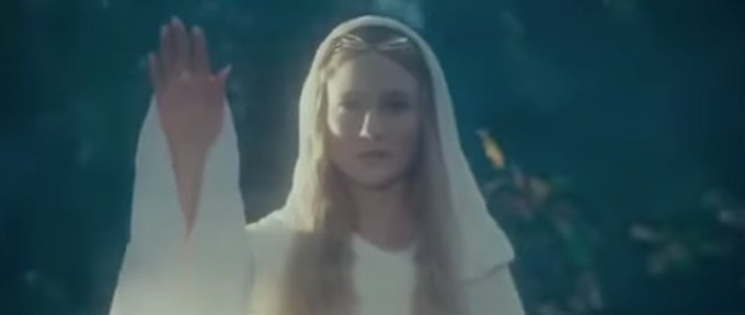 The image features an actress standing in front of trees with her hand raised up. She appears to be dressed in white clothing, which contrasts with the surrounding greenery. The background consists of a forested area, adding depth to the scene. The caption above the image reads "May Bitcoin be a light for you in dark places", suggesting that the actress' presence and the act of raising her hand could symbolize hope or illumination during difficult times.

The post is written by someone named "Bob".