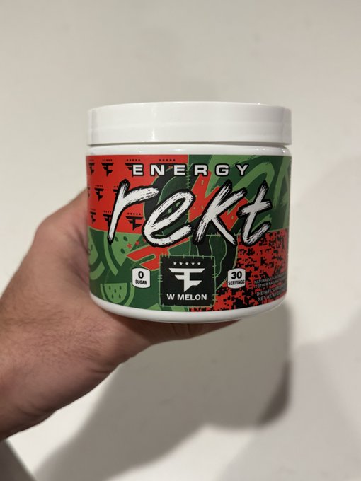 A tub of "Energy Rekt" watermelon-flavored energy powder labeled with 0 sugar and 30 servings is held up, aligning with the caption about switching from energy cans to powdered form.