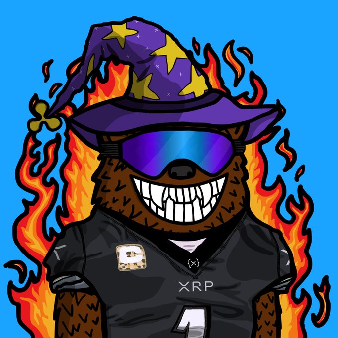 A cartoon illustration of a grinning bear wearing a purple wizard hat with yellow stars, reflective blue goggles, and a black XRP jersey, surrounded by flames against a blue background.