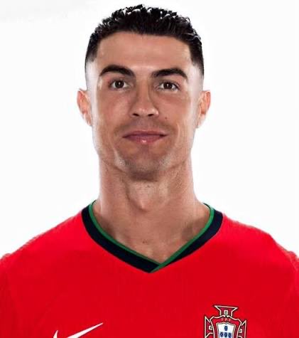 A headshot of soccer player Cristiano Ronaldo wearing a red Portugal national team jersey with green trim and the team crest.
