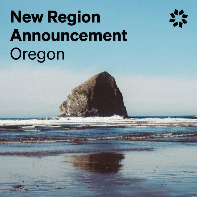 An announcement graphic reading 'New Region Announcement Oregon' with a photo of a large sea stack rising from the ocean waves on a beach, with a starburst logo in the top right corner.
