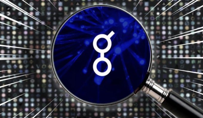 The image features a magnifying glass with a blue circle containing a white "G" symbol at its center. The magnifying glass appears to be held over an image or text, possibly related to cryptocurrency or blockchain technology.