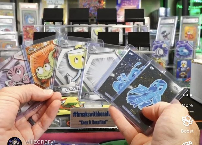 A person displaying a fan of Pokemon trading cards, including what appears to be Mewtwo cards, in a retail store with card displays and a 'Boostsider' hashtag visible, from a post by user 'viiiionary'.