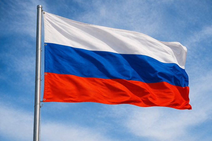 The Russian tricolor flag waves against a blue sky, symbolizing Russia's national context for Sberbank's announcement of launching a crypto wallet and digital custody service by December, which will bring regulated digital asset access to its banking apps.