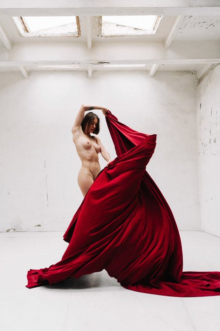 "Unveiled" is an NFT of a woman draped in a flowing red fabric, presented as a 1/1 edition for 400 XTZ.