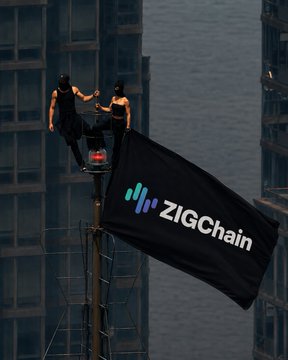 Two performers balance atop a flagpole displaying a "ZIGChain" banner with its colorful logo, set against a city skyline backdrop. The striking image of heights and stability visually echoes the trader's confidence in holding a long position on $ZIG as price retests support.