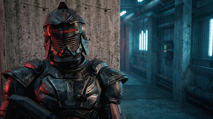 A figure in futuristic black and silver sci-fi armor with a glowing red visor stands in a dimly lit industrial corridor.