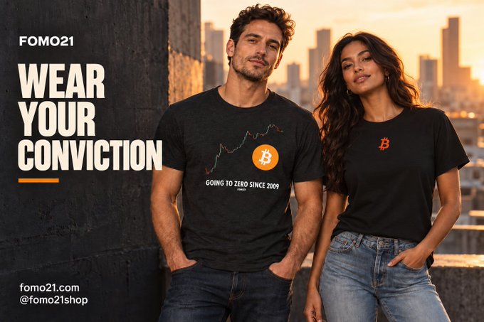 A promotional ad for fomo21.com featuring a man and woman modeling black Bitcoin-themed shirts, with text reading 'WEAR YOUR CONVICTION' and 'GOING TO ZERO SINCE 2009'.