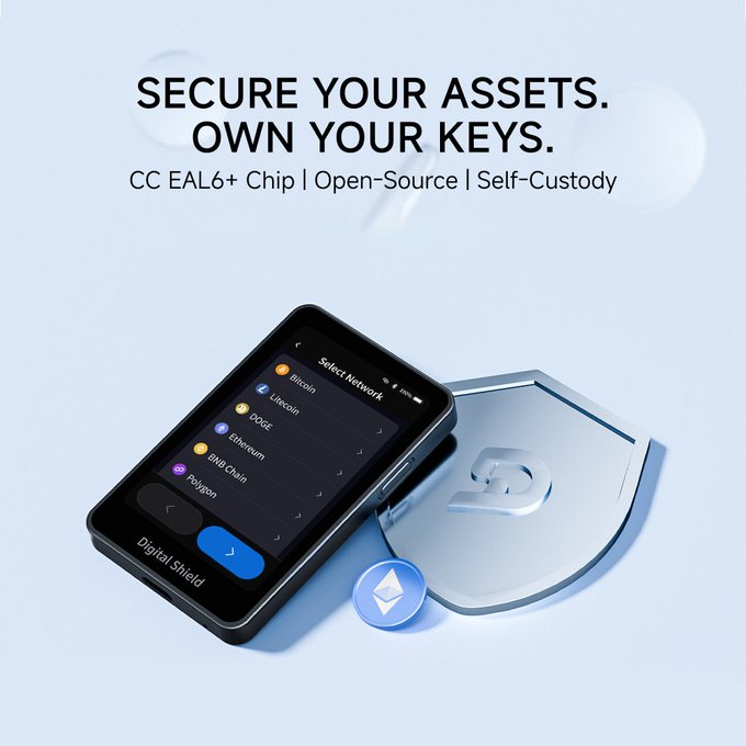 A crypto hardware wallet advertisement with the text "SECURE YOUR ASSETS. OWN YOUR KEYS. CC EAL6+ Chip | Open-Source | Self-Custody," featuring a Digital Shield device displaying a "Select Network" menu with Bitcoin, Litecoin, DOGE, Ethereum, BNB Chain, and Polygon.