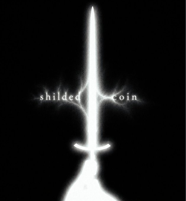 A glowing white sword is depicted against a dark background, with the words "shielded" and "coin" flanking the blade like a crossguard. The image visually reinforces the "$ShieldCoin" branding, symbolizing protection and strength for the upcoming Bitcoin-based token launch.