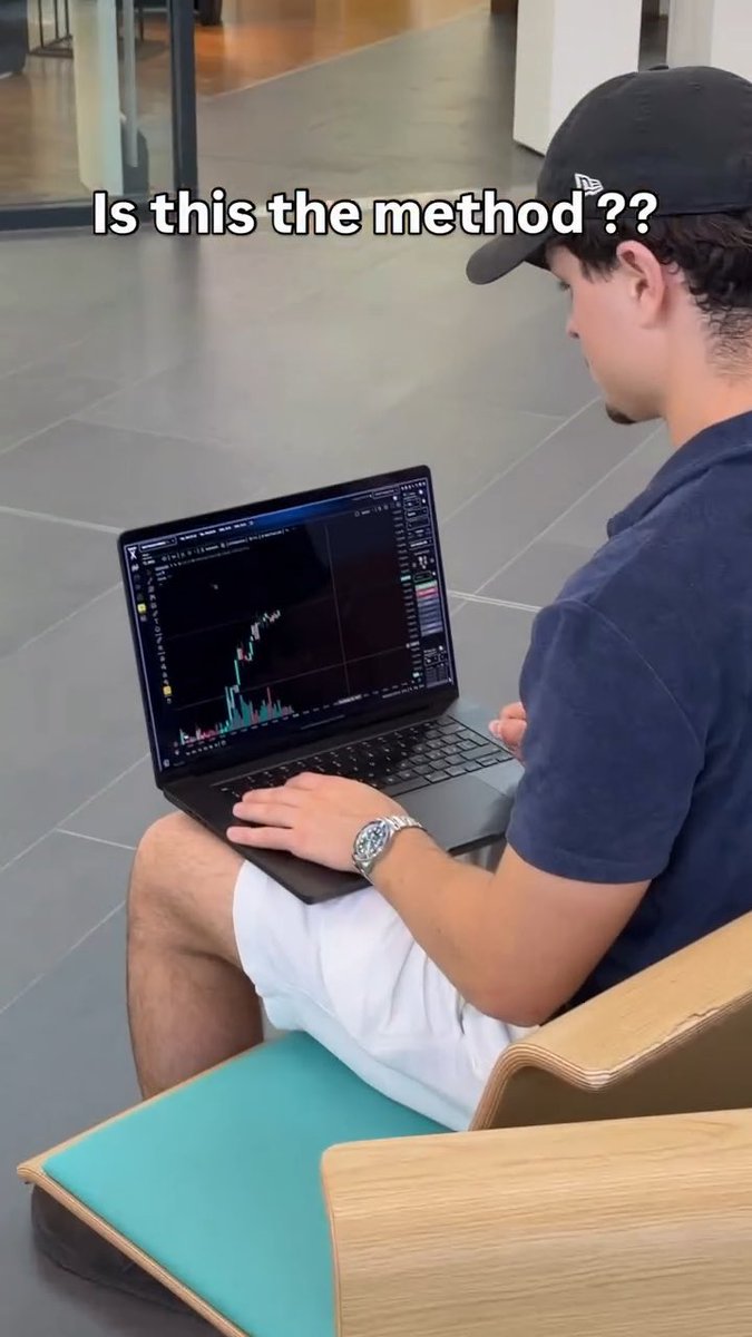 A young man wearing a black cap and navy shirt sits outdoors with a laptop on his lap showing a trading chart, with overlaid text reading 'Is this the method??' questioning a trading technique.