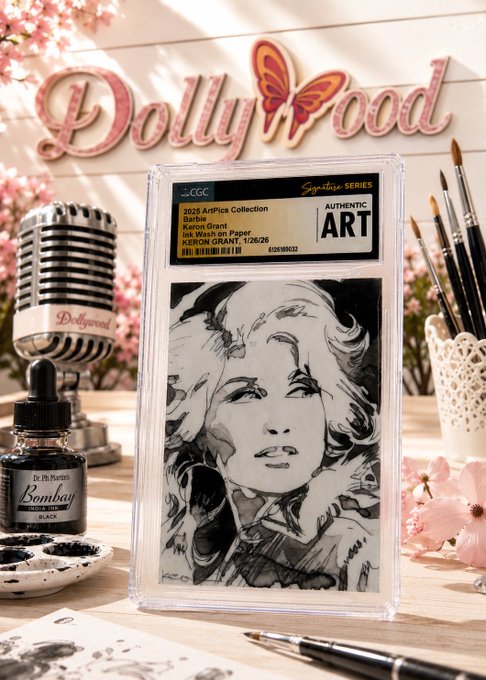 A graded art card featuring a black and white drawing of Marilyn Monroe, labeled '2025 Artfact Collection' and 'Marilyn Grant', displayed with art supplies against a 'Dollywood' sign.