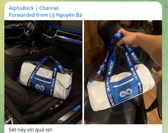 A promotional image from AlphaBack Channel showing a white and blue MEXC-branded duffel bag with "MEXC" patterned straps, displayed both inside a BMW car interior and being held up by hand. The Vietnamese caption "Set này quá xịn" (This set is so awesome) along with the post text confirms this is showcasing a premium gift set from MEXC Vietnam.