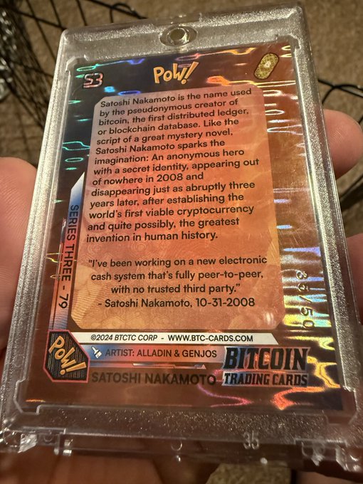 The back of a holographic 'Bitcoin Trading Cards' collectible card #79 featuring Satoshi Nakamoto, with text describing him as the pseudonymous creator of bitcoin, published by BTC0 Corp.