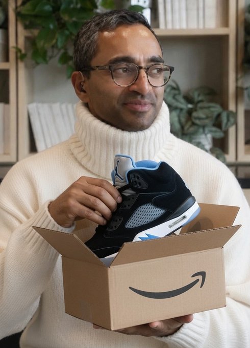 A man wearing glasses and a cream turtleneck smiles while holding an open Amazon cardboard box containing a black and blue sneaker, visually playing on the "SP3ND" wordplay by suggesting retail spending.