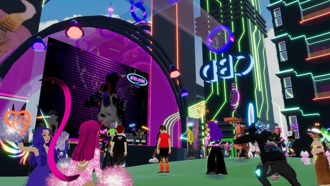 The image shows a group of people gathered at an event called "Canessa DCL" for the 4th year anniversary. The attendees are enjoying themselves as they watch a live stream from the event. There are several people standing around, some closer to the camera and others further away. A few individuals can be seen in the foreground, while others are scattered throughout the scene. 

The background features neon lights that add a vibrant atmosphere to the event space. The image also includes text elements such as "@SinfulMeatStick" and "@CanessaDCL", which may provide additional information about the event or its organizers.