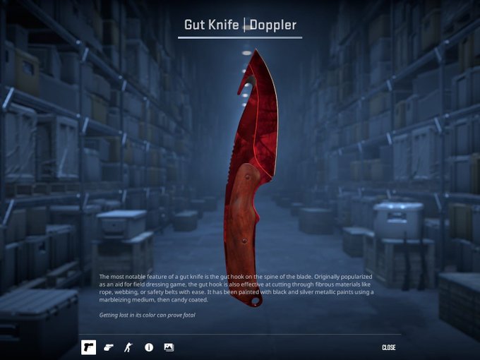 A CS2 weapon inspection screen displays a red Doppler Gut Knife with descriptive text about the gut hook feature against a warehouse background.