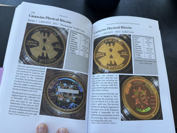 The image shows a book open to a page about physical bitcoins, which are described as "beautiful" and "golden." The book also contains images of various coins, including one with a person holding it. The title of the book is "Physical Bitcoins" and it appears that someone has posted something interesting on social media related to this topic.