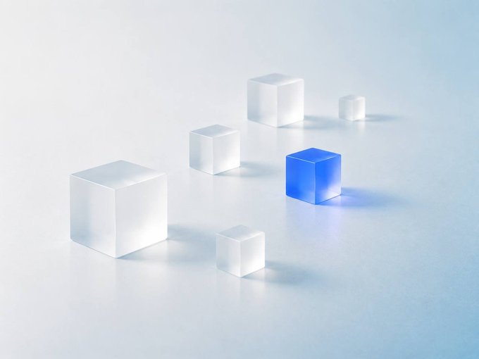 A minimalist 3D rendering shows several translucent white cubes and one solid blue cube arranged on a pale surface, symbolizing the concept of receiving shares (NVDA stock) directly in your wallet with every swap, where the lone blue cube stands out among the white ones to represent the unique stock reward delivered alongside a transaction.
