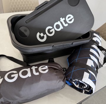 A black "Gate" branded VR headset case sits open next to two matching "Gate" carrying pouches.