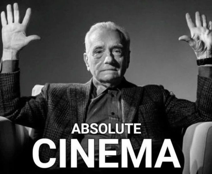 A black-and-white meme of an older man with his hands raised in surrender, captioned 'ABSOLUTE CINEMA'.