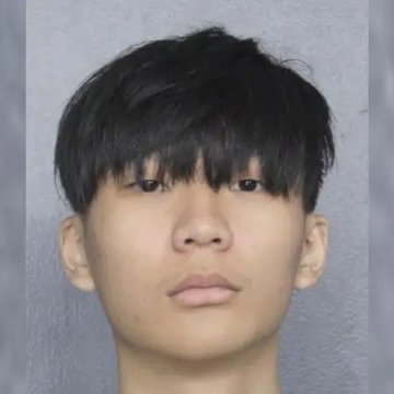 A mugshot-style photo of a young East Asian man with dark hair, likely depicting the 22-year-old suspect described in the post who pleaded guilty to stealing $245 million in Bitcoin.