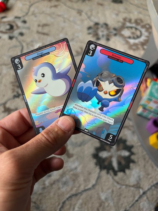 A hand holds two holographic Pokémon trading cards, "Pengu" (Character | Trainer, cost 3) and "Hitmonlee" (Traditional, cost 3, power 5), with the shimmering foil Pengu card matching the post's excitement about pulling a clean foil from newly ripped packs.