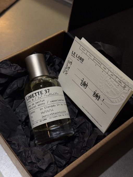 A bottle of Le Labo 'Limette 37' eau de parfum, 50ml, personalized for Jerry, rests on black tissue paper inside a brown gift box alongside a 'Thank You' card.