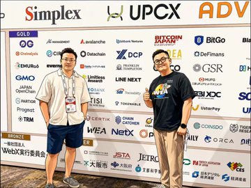 Two men posing in front of a sponsor backdrop at a WebX event, with logos including Simplex, UPCX, ADV, Bitcoin, and ChainCatcher visible.