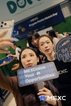 The image features a group of people posing for a photo at an event called "pickleball", which appears to be related to cryptocurrency or crypto events, as indicated by the text in the image. The attendees are holding up signs with messages such as "MEXC" and "pickleball". There is also a person taking a selfie using their phone. In addition to these elements, there are other people present at the event who might be participating in or observing the pickleball game.