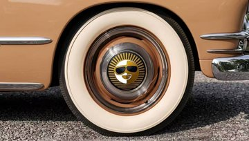 A classic car's wheel with a chrome hubcap and whitewall tire is shown, appearing unrelated to the accompanying post about TRON's ecosystem expansion and MetaMask integration.