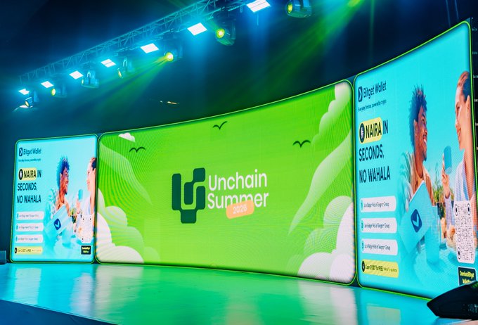 A vibrant stage display showcases the "Unchain Summer 2020" branding across three large LED screens, featuring bright green and blue graphics with the slogan "Whala in seconds, no wahala" alongside a stylized male character. The setup includes overhead stage lighting and appears to be promotional branding for the Unchain Summer event, aligning with the post's praise for the event's standout design work.