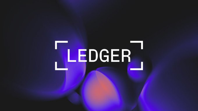 The image features the word "LEDGER" displayed in a white sans-serif font, framed by corner brackets against a dark background with glowing purple and blue orbs. This visual aligns with the post's message about Ledger's AI integration, where the camera/viewfinder-style framing of the logo reinforces the idea of AI agents being able to "see" wallet information while the secure, contained design suggests the protective boundaries that prevent unauthorized transactions.